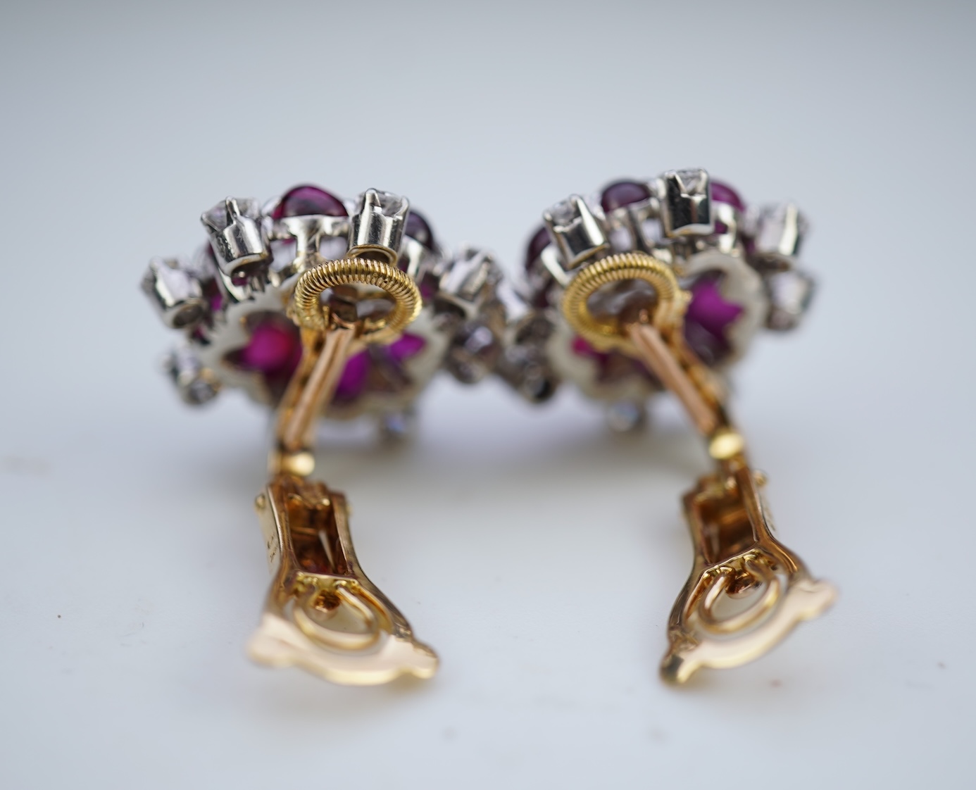 A pair of ruby and diamond ear clips, mid 20th century